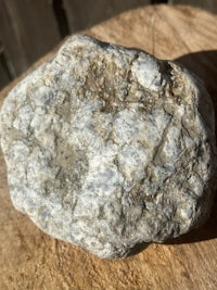 a rock sitting on top of a wooden surface