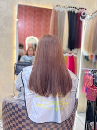 a woman sitting in a chair at a hair salon