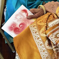a woman in a sari holding a card