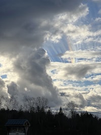 a cloudy sky with a rainbow in the sky