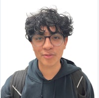 a young man with glasses and a backpack