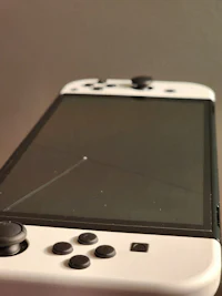 a white nintendo switch sitting on a table