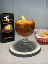 a bowl of soup sits on a table next to a box