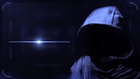 an image of a hooded man in a dark room