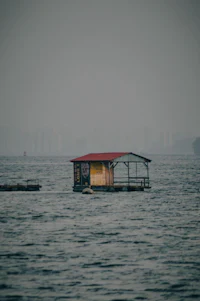 a small house floating in the middle of the water