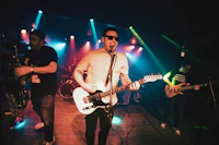 image may contain person, on stage, playing a musical instrument and night