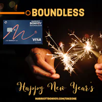 a person holding a sparkler with the words boundless happy new year