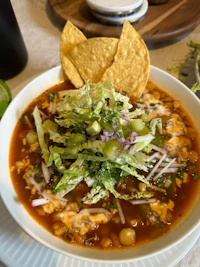 a bowl of mexican soup on a table