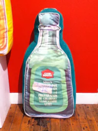 a pillow with a bottle on it