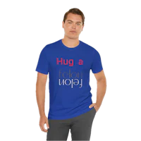 a man wearing a blue t - shirt that says a hug a year