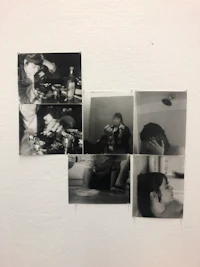 a group of photographs on a white wall