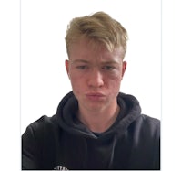 a young man in a black hoodie is taking a selfie