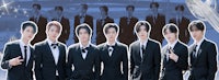 a group of men in suits posing for a picture