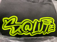 a black hoodie with a green logo on it