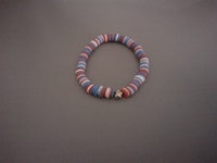 a bracelet with red, blue and white beads