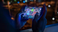 a person playing a game on a smartphone at night