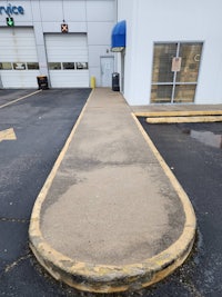 a parking lot with a circular driveway in front of a building
