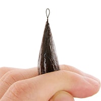 a person's hand holding a small piece of black hair