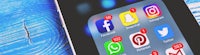 a cell phone with social media icons on it