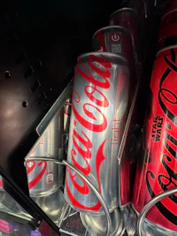 coca cola cans in a refrigerator