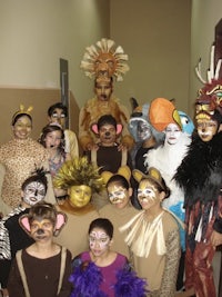 a group of children dressed in animal costumes posing for a photo