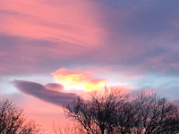 a pink and purple sky with a cloud in the sky
