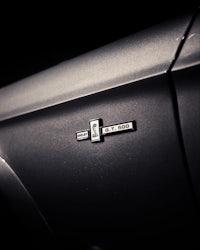 a close up of a badge on a black car
