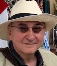 a man wearing a hat and sunglasses