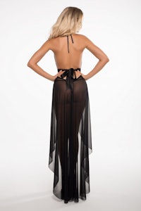 the back view of a woman in a black halter dress