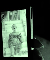 a person holding a cell phone in the dark