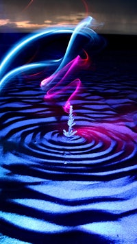 a light painting of a wave in the water