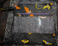 a zipper pouch with bats on it