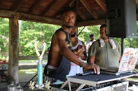 a man with a shirt on is playing a dj