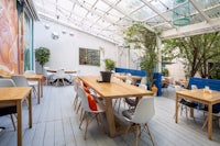 a restaurant with tables and chairs in a greenhouse
