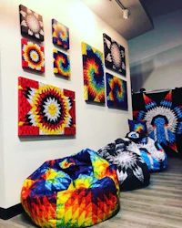 a room full of colorful bean bags and paintings