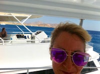 a woman wearing sunglasses on a boat
