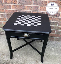 a black side table with a chess board on it