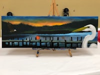 a painting of a white egret on a easel