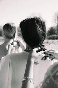 black and white photo of bridesmaids putting their hair up