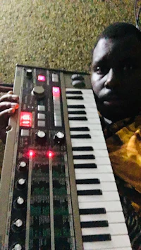 a man holding a synthesizer in his hands