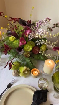 a table setting with flowers and candles