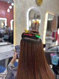 a woman with long brown hair in a salon
