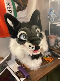 a stuffed wolf head is sitting on a table