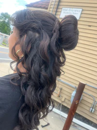 the back of a woman with long curly hair