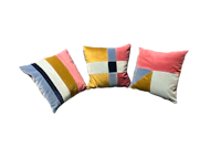 three colorful pillows on a black background