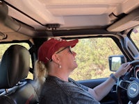 a woman driving a jeep