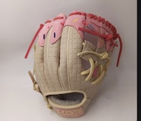 a baseball glove with a pink and white design