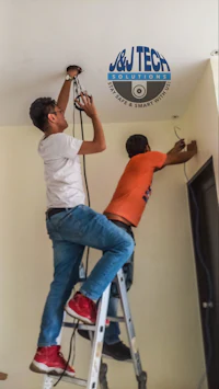 two men working on a ladder in a room