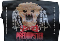 a black t - shirt with an image of a predator with a bow tie