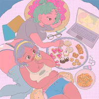 a girl is laying on a bed with a laptop